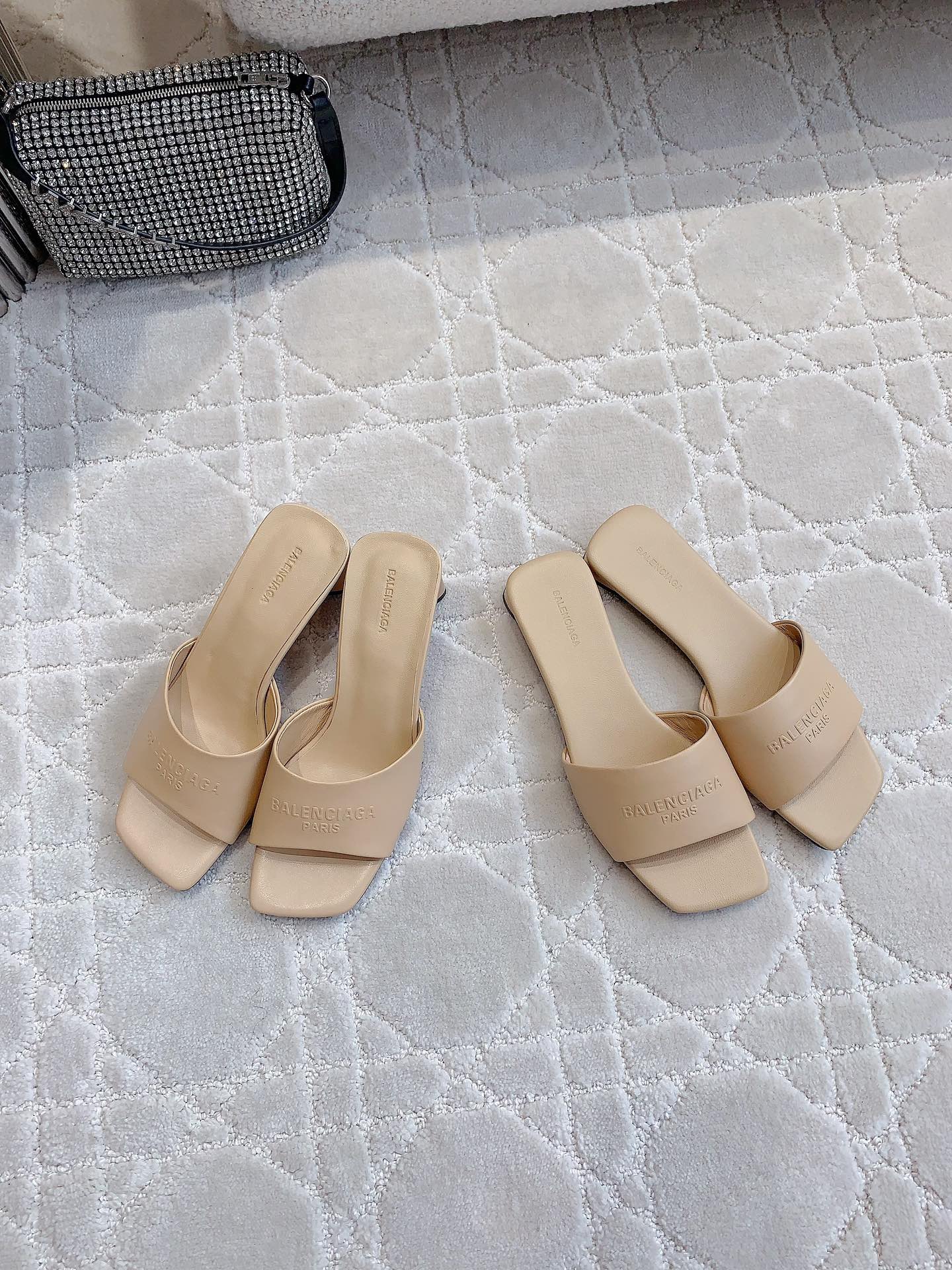 Beige slip-on slide sandals with square toe and embossed logo