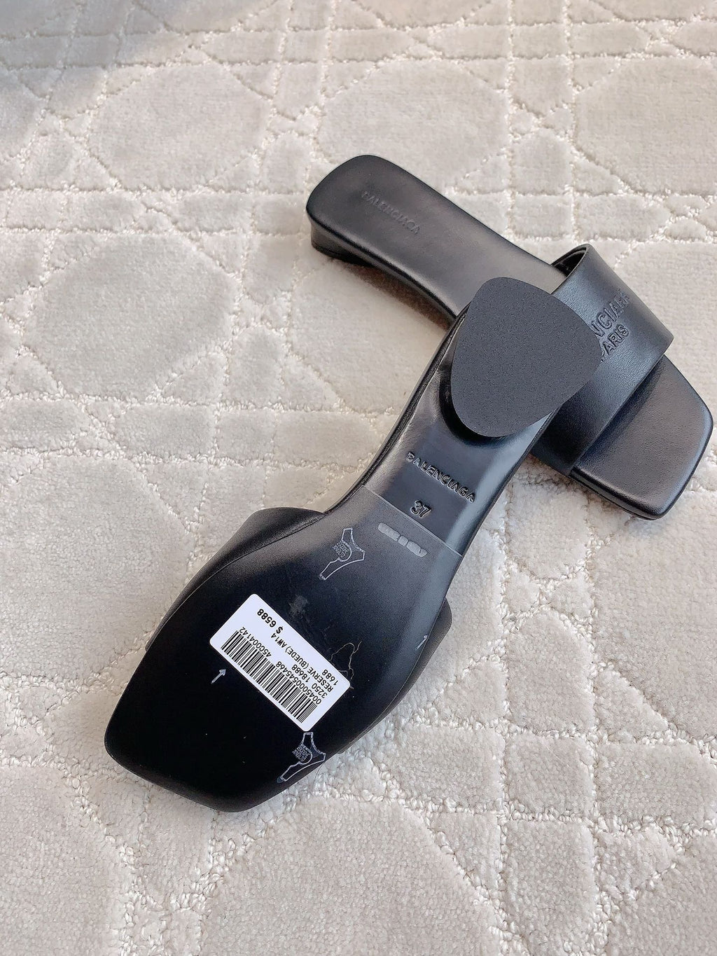 Balenciaga slide sandals, dark heel view with strap and logo marks on sole