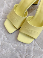 Yellow slide sandals with Balenciaga PARIS embossed on straps