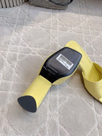 Yellow slide sandal with black size label on the insole