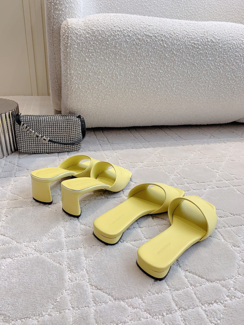 Pair of yellow slide sandals with low block heels and open back