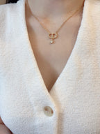 Gold-tone Dior pendant necklace on white knit top with small crystal D pendant
