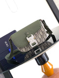 Green flap crossbody bag with beige monogram canvas and silver buckle hardware