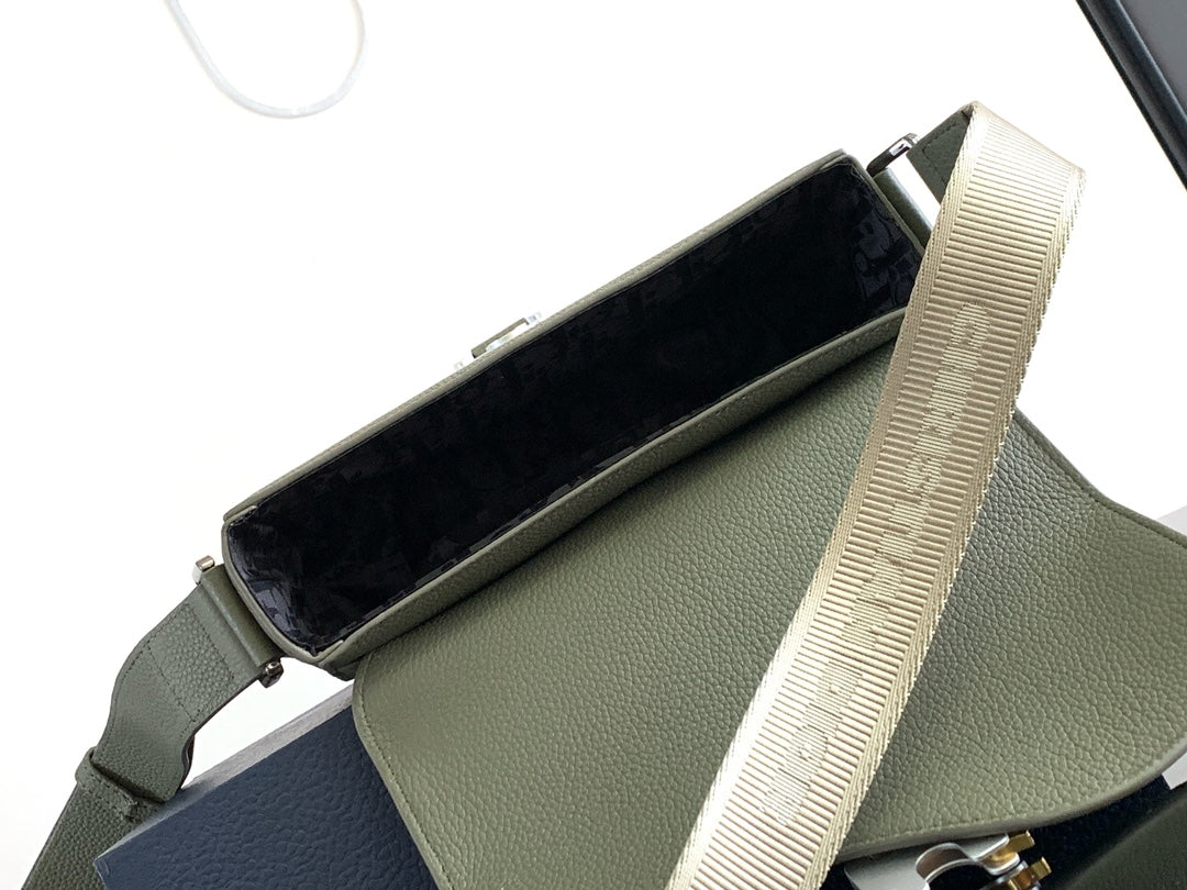 Dior men’s green leather bag interior with dark lining and beige webbing strap