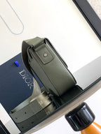 Dior men’s green leather bag with top handle and front flap clasp hardware