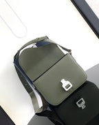 Dior men’s green leather bag with white buckle detail and adjustable shoulder strap