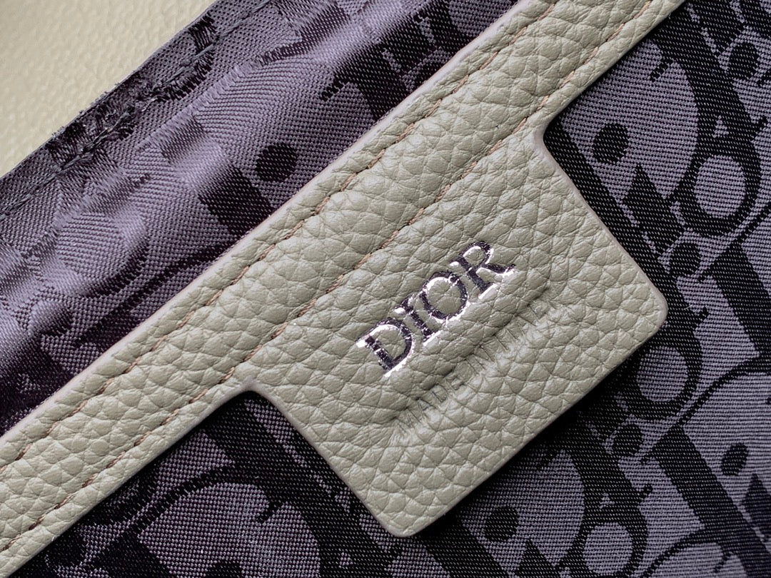 Dior men’s bag lining pocket with beige label and dark monogram pattern