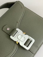 Dior green leather bag close-up with silver CD logo clasp and strap hardware