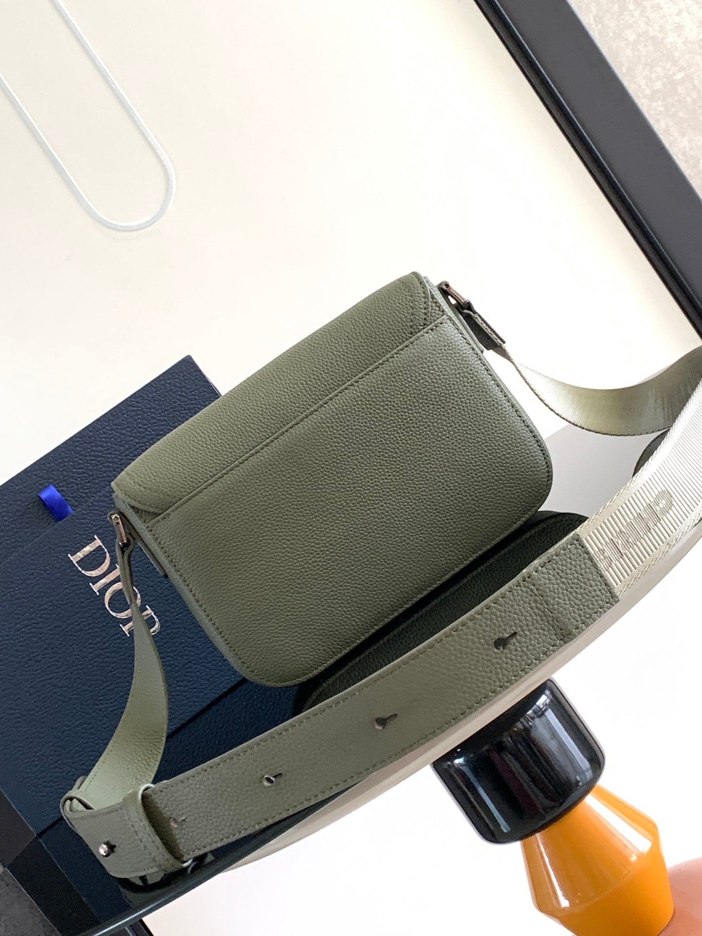 Dior men’s green leather crossbody bag with front flap and adjustable strap
