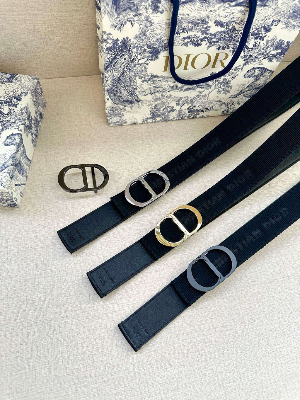 Set of three dark blue Dior belts with circular buckles and branding