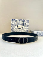 Dark blue Dior belt with circular metal buckle and perforated strap holes