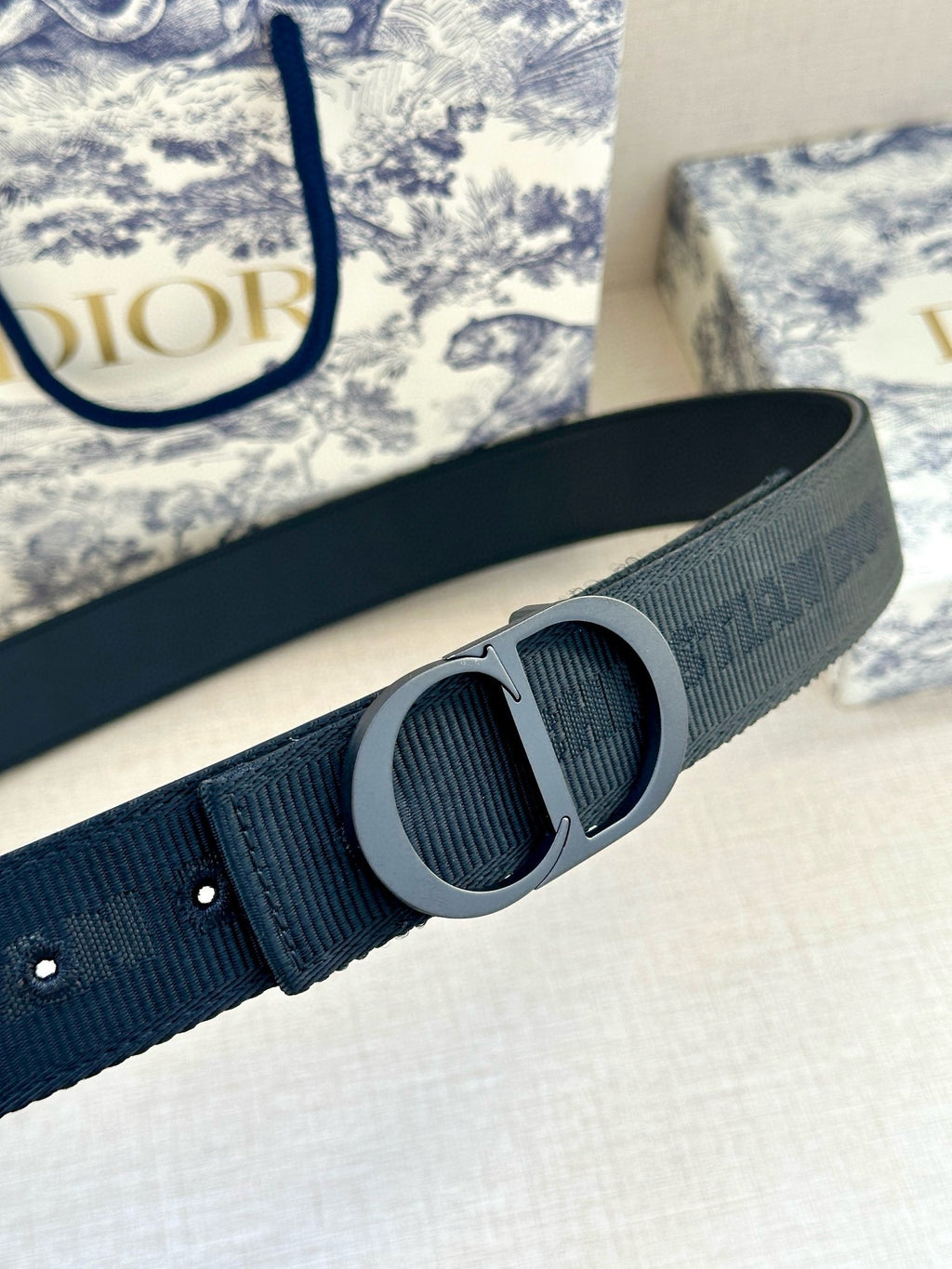 Dark blue belt close-up with gray circular double-ring buckle