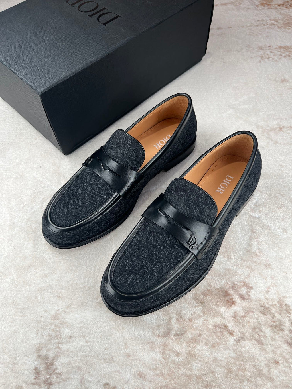 Black Dior unisex loafers pair with strap and textured finish