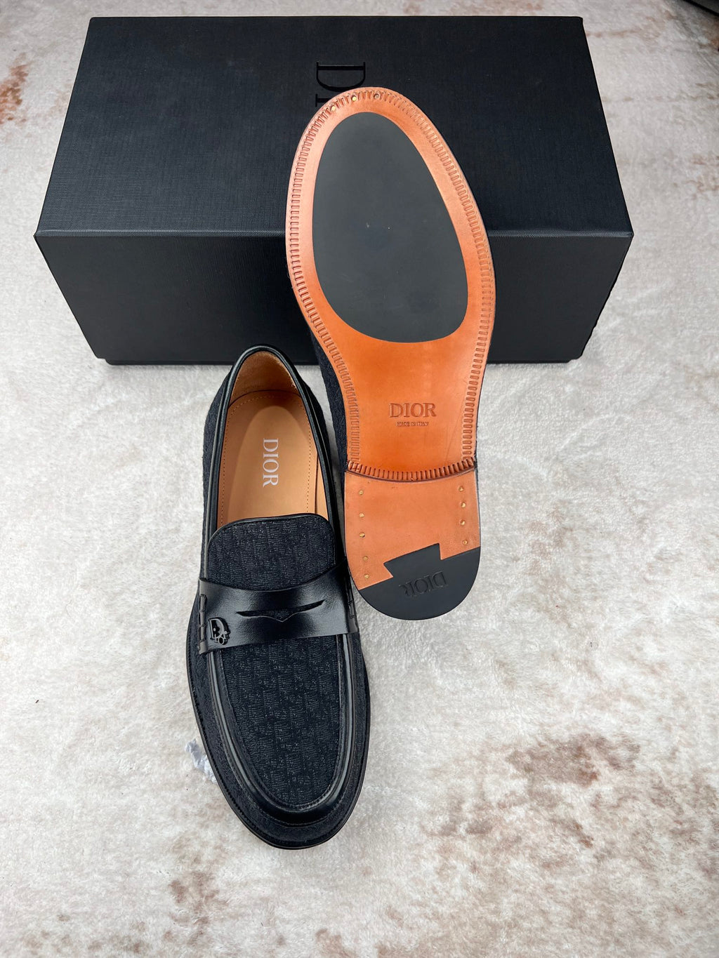 Black Dior unisex loafers with tan and orange insole underside