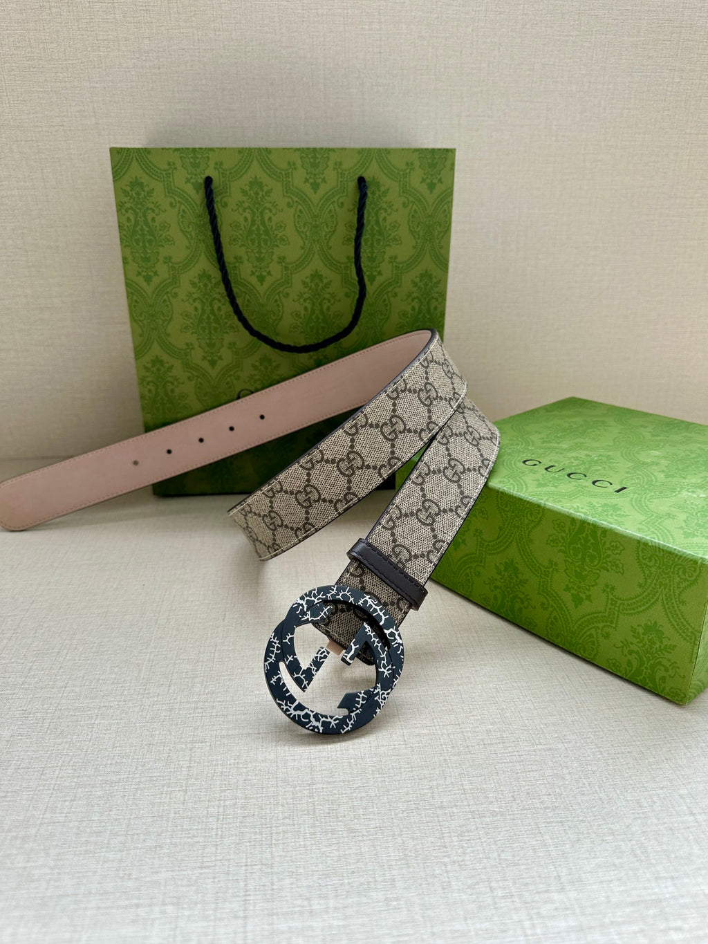 Gucci belt with beige GG canvas, dark buckle with blue pattern, adjustable strap