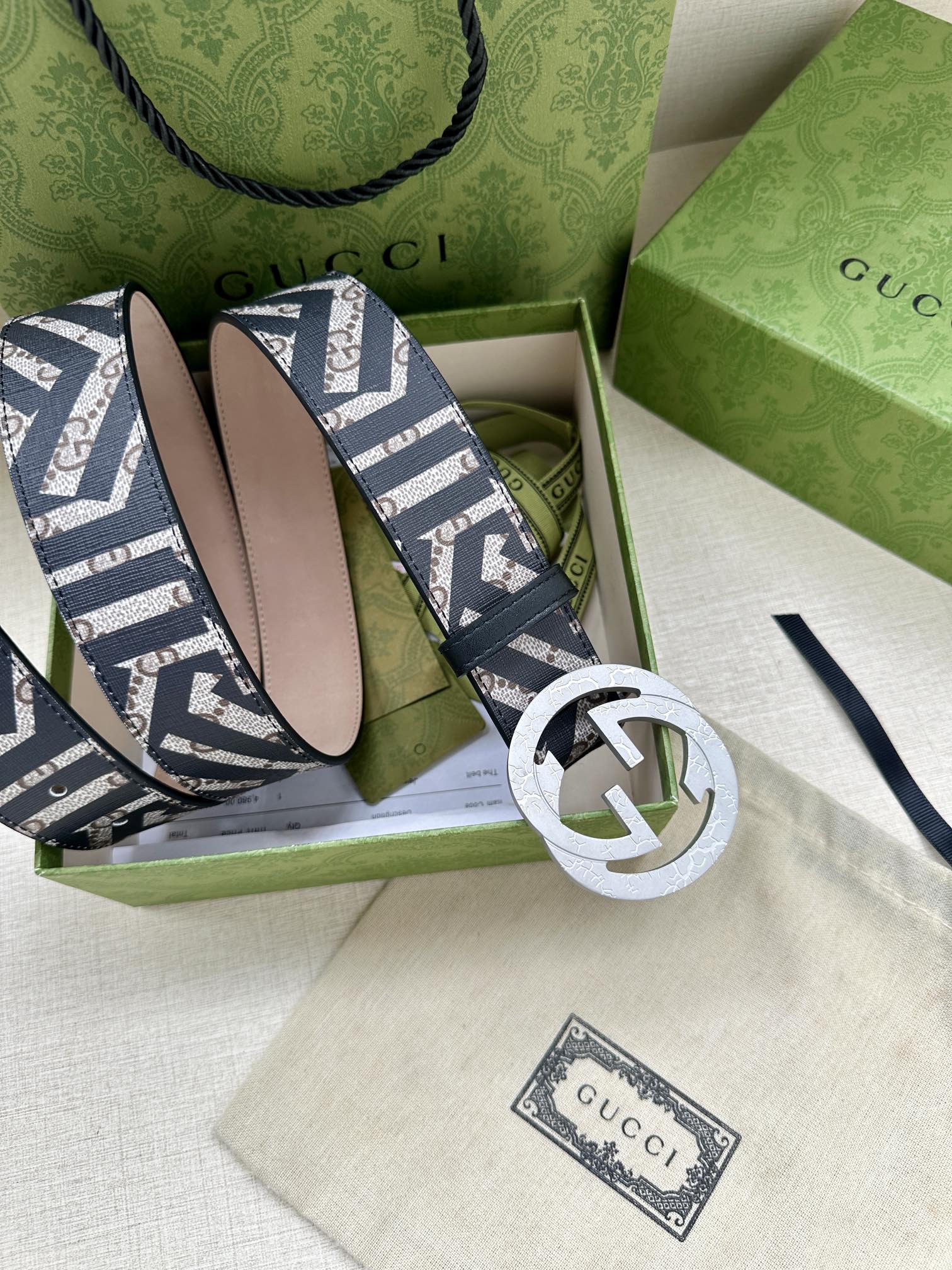 Gucci monogram belt with navy-and-white strap and silver-toned interlocking circular buckle