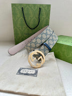 Gucci belt with GG canvas strap, blue edge trim, and gold-toned circular buckle on pouch.