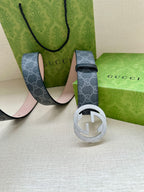 Gucci belt with dark blue GG strap and round silver-toned buckle