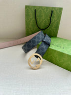 Gucci belt with dark blue GG strap and gold-toned circular buckle