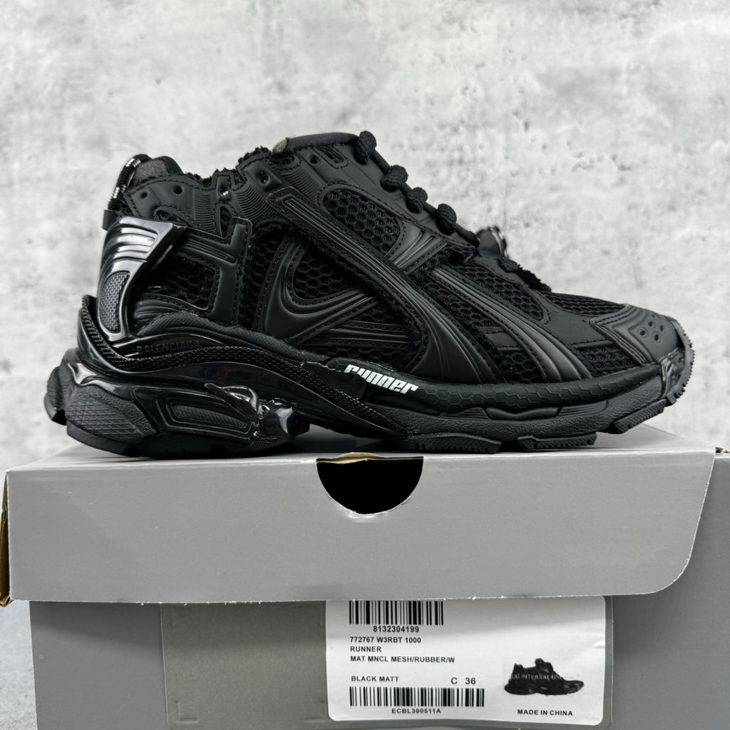 Balenciaga unisex black sneakers with chunky soles, side profile, lace-up design