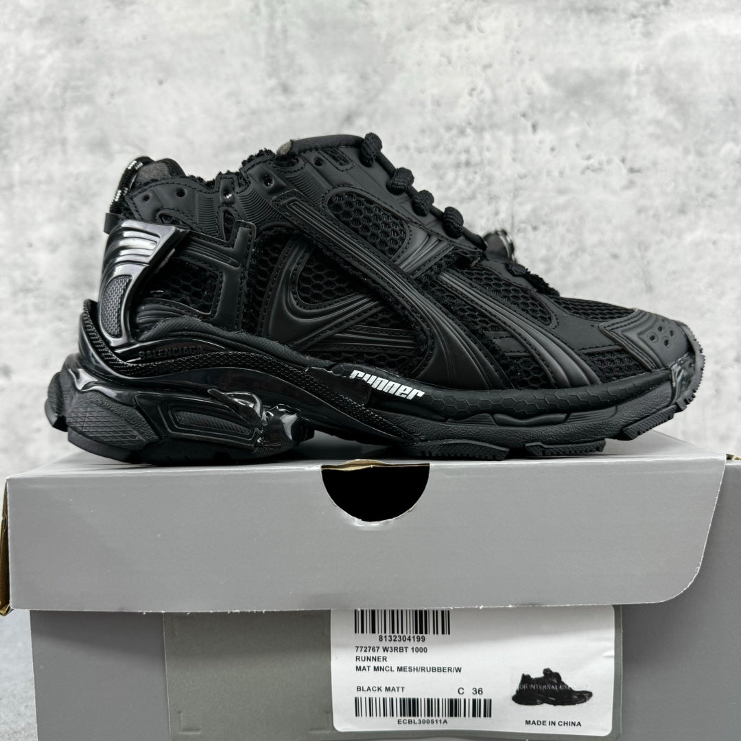Balenciaga unisex black sneakers with chunky soles, side profile, lace-up design