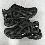 Balenciaga unisex black running-style sneakers, mesh and stitched panels, lace-up pair