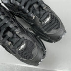 Balenciaga unisex black sneaker tongue and lace area, mesh panels with BALENCIAGA logo