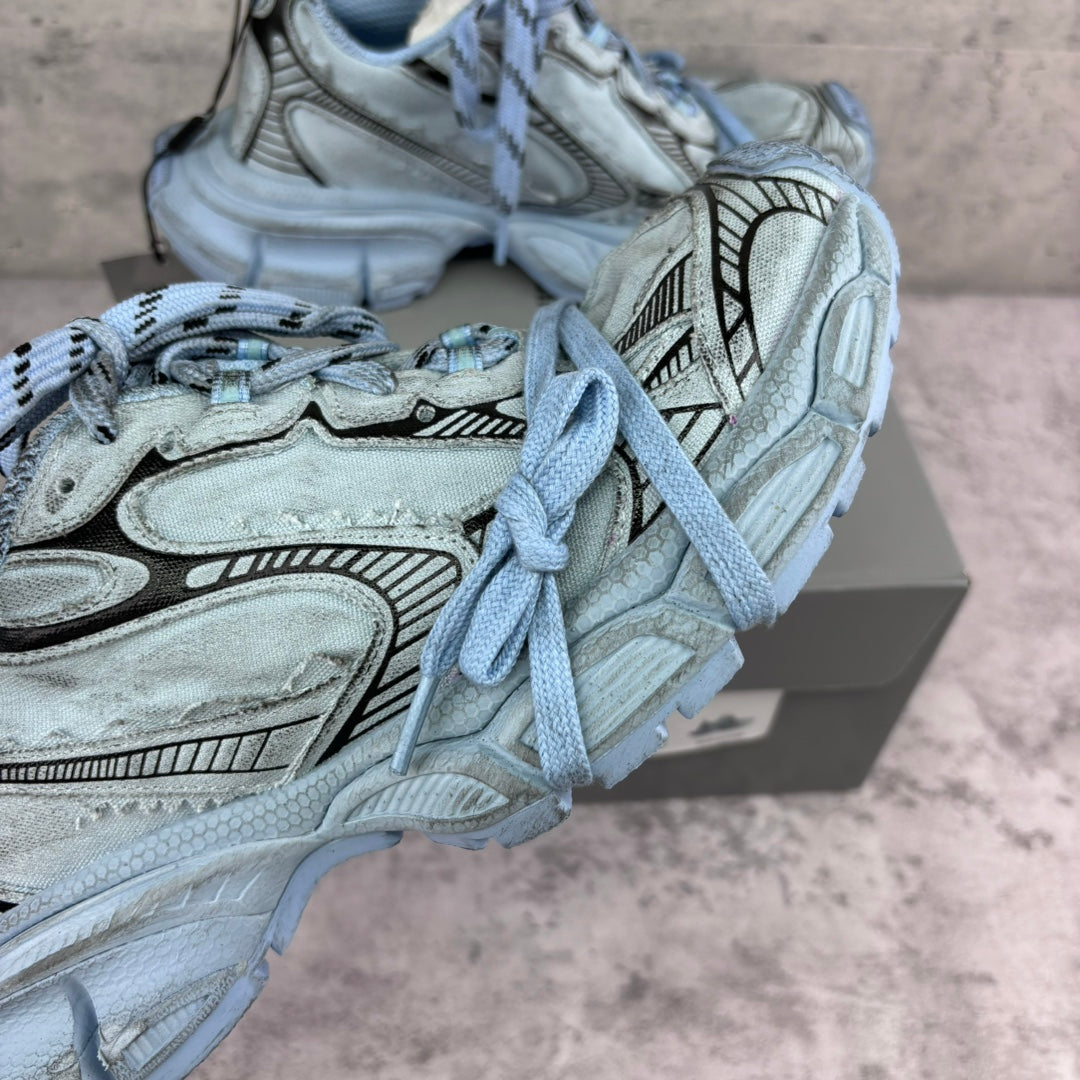 Unisex sneakers close-up, light blue panels and laces, patterned overlays, chunky sole