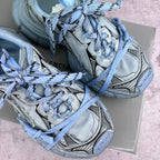 Unisex sneakers top view, light blue laces, suede-like panels with graphic stripe overlays