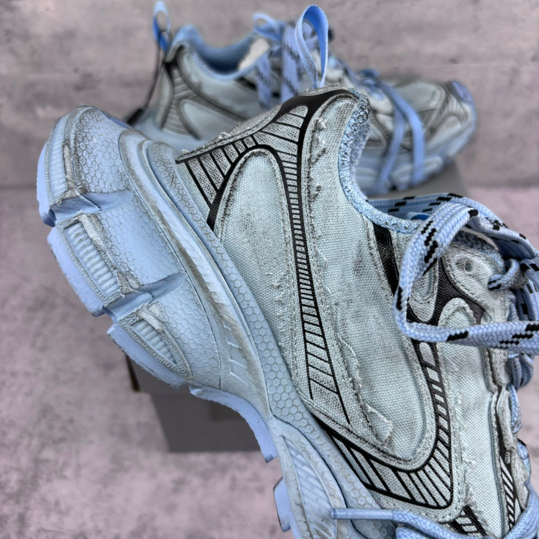 Unisex sneakers side view, light blue suede-like upper, black pattern trim, lace-up