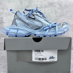 Unisex sneakers on box, light blue and silver, lace-up design with patterned side panels