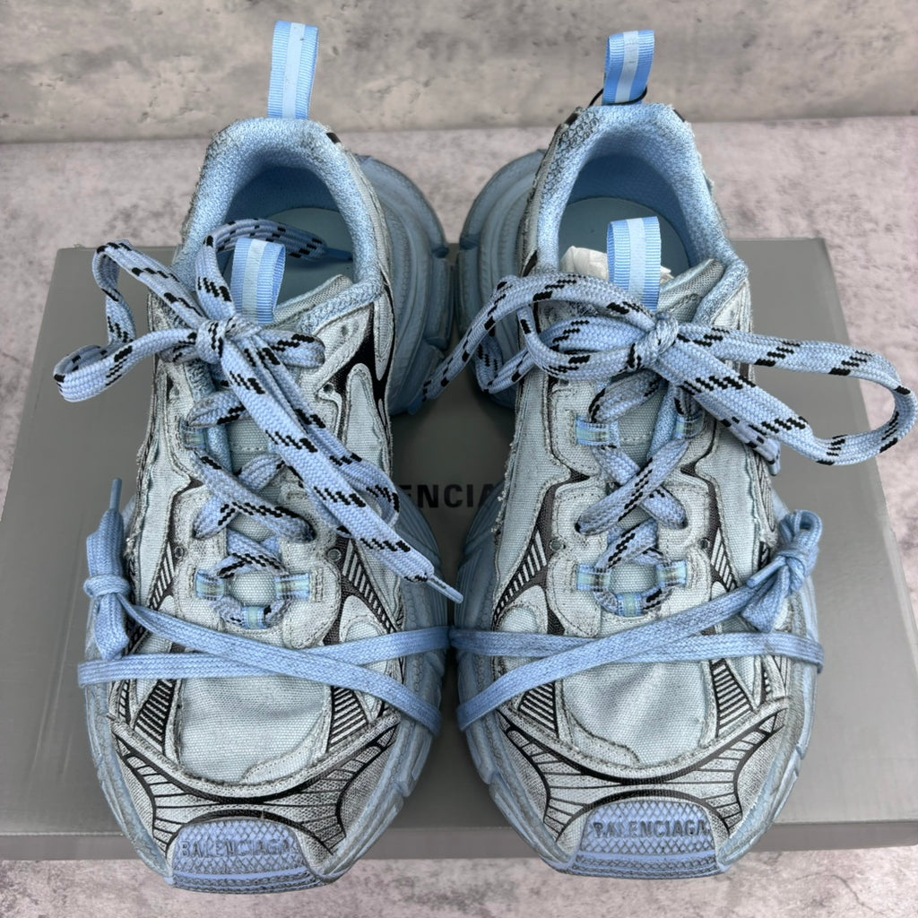 Unisex sneakers front view, light blue uppers with padded tongue and blue lace-up closure