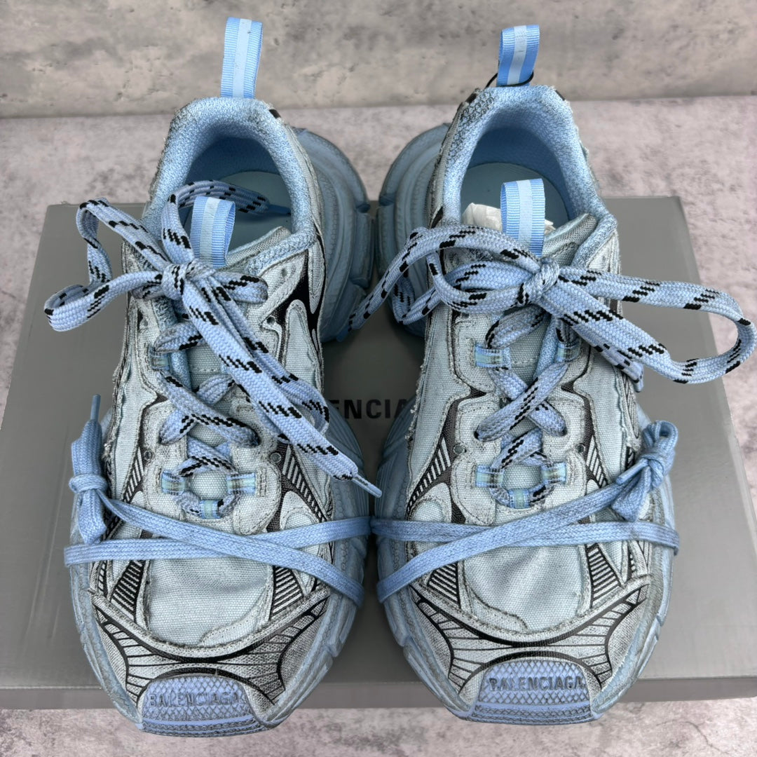 Unisex sneakers front view, light blue uppers with padded tongue and blue lace-up closure