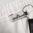 White shorts waistband with Stone Island brand label tag