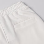 White shorts with elastic waistband and front rectangular patch pocket