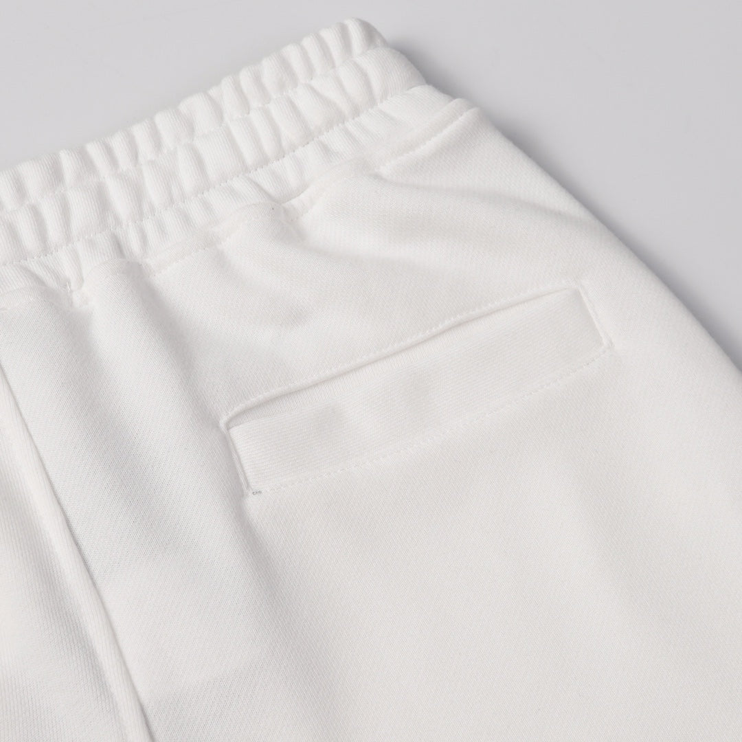 White shorts with elastic waistband and front rectangular patch pocket