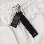 Stone Island white drawstring shorts with elastic waistband, hanging label