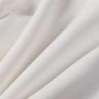 White shorts fabric with soft drape and stitched seams