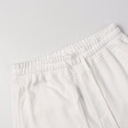 White shorts showing elastic waistband and front drawstring