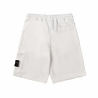White shorts with elastic waist, front drawstring, and side cargo-style pocket