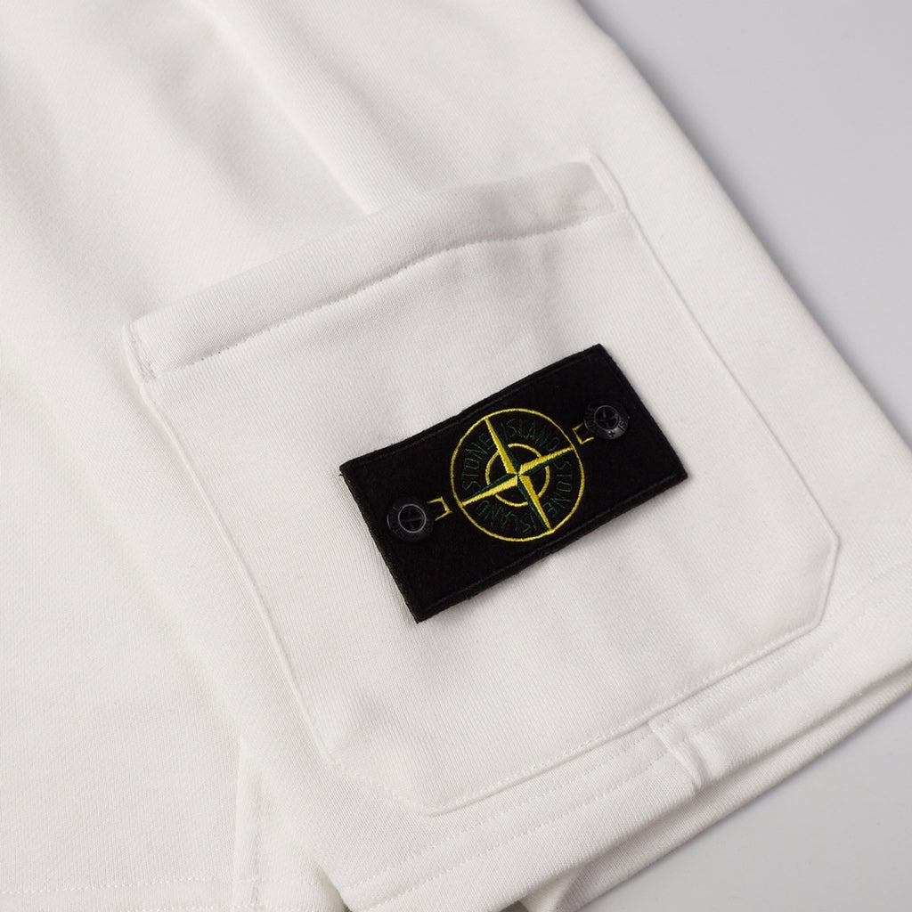 White shorts pocket with black Stone Island patch logo