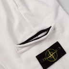 White shorts with zip pocket opening and black Stone Island patch logo