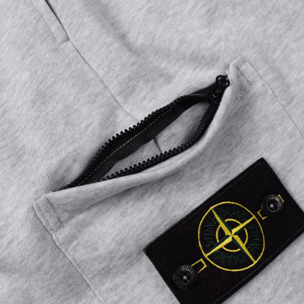 Stone Island shorts drawstring area with black patch and yellow emblem