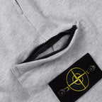 Stone Island shorts drawstring area with black patch and yellow emblem