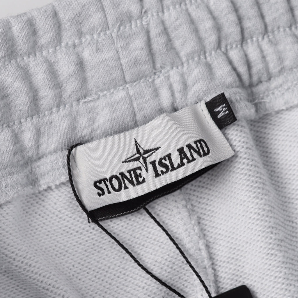 Stone Island clothing fabric with logo label patch and black trim