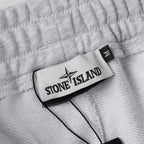 Stone Island clothing fabric with logo label patch and black trim