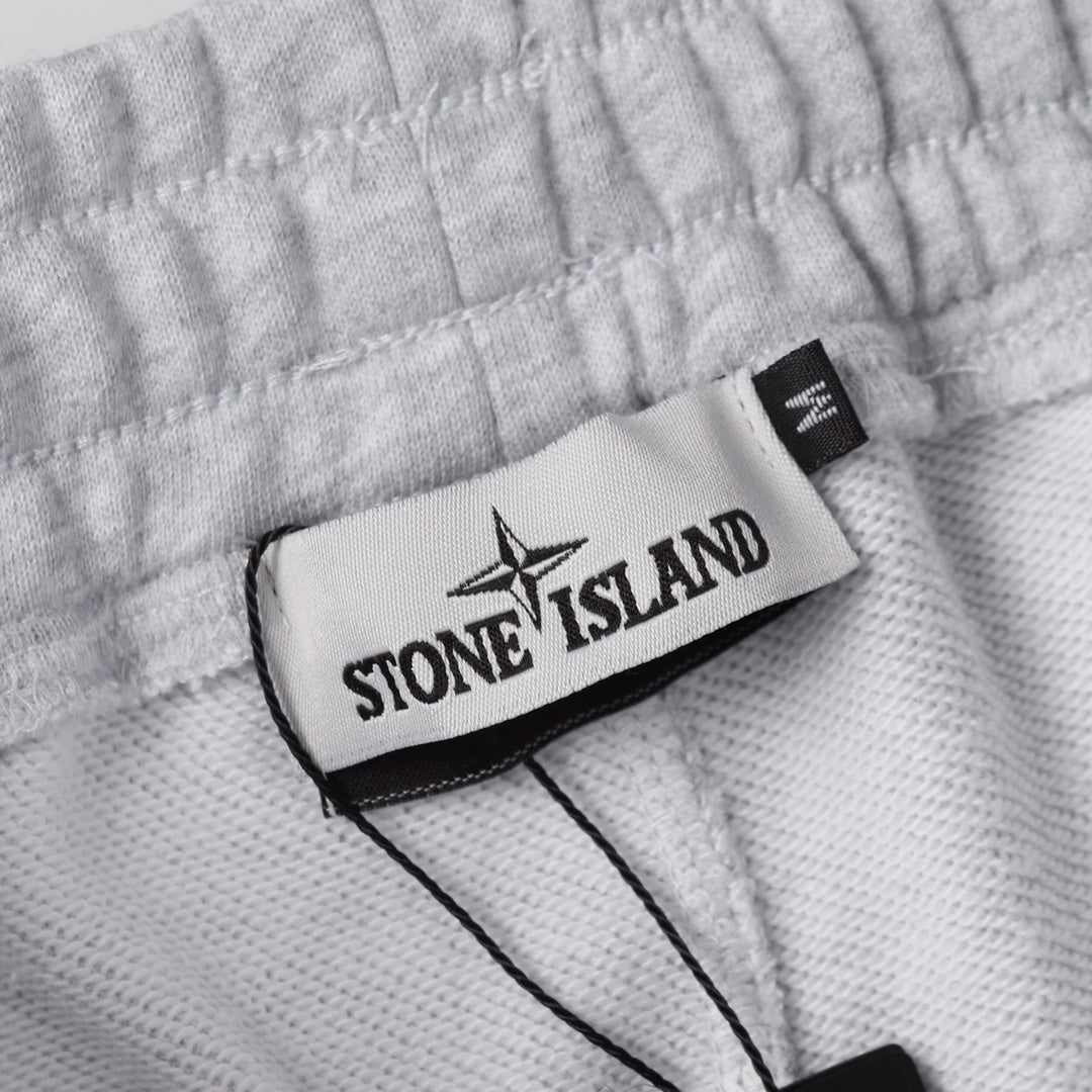 Stone Island clothing fabric with logo label patch and black trim