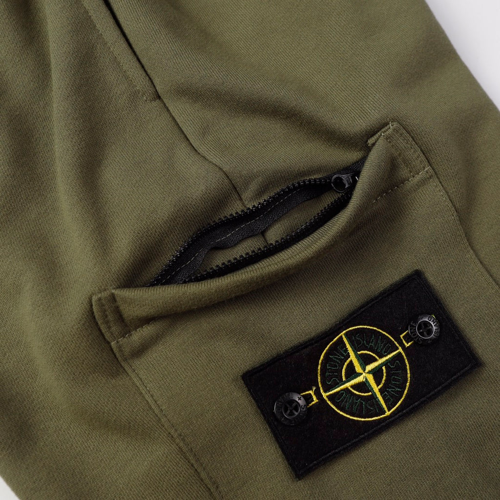 Olive shorts detail showing black inner lining and Stone Island logo patch