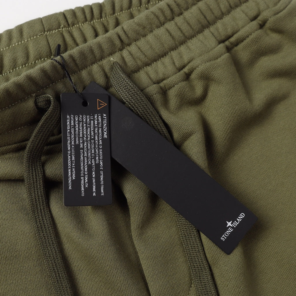 Olive shorts waistband with attached care tag and drawstring