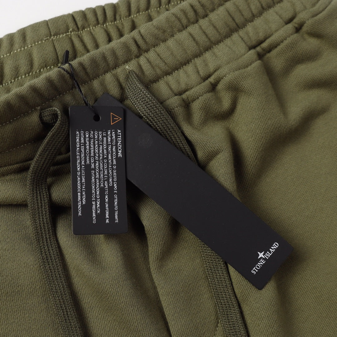 Olive shorts waistband with attached care tag and drawstring